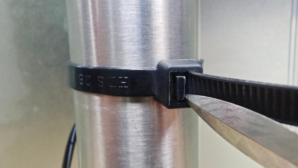 Use a flathead screwdriver to release the cable ties